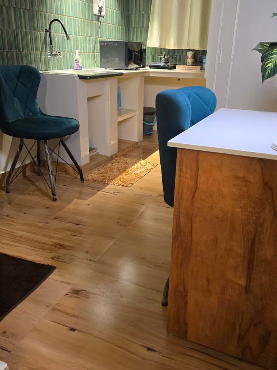 The studio's kitchen and dining corner with warm wood floors